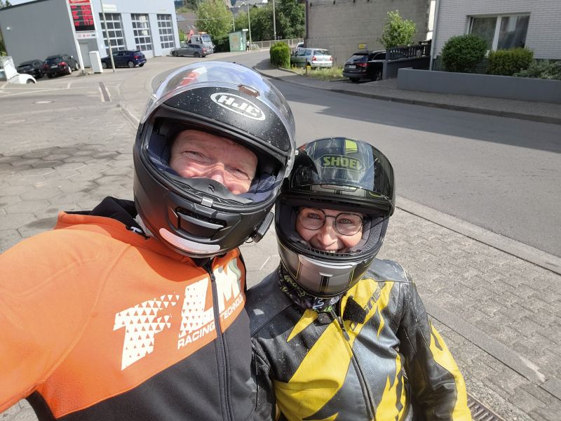 Zwei Motorradfahrer lächeln in die Kamera